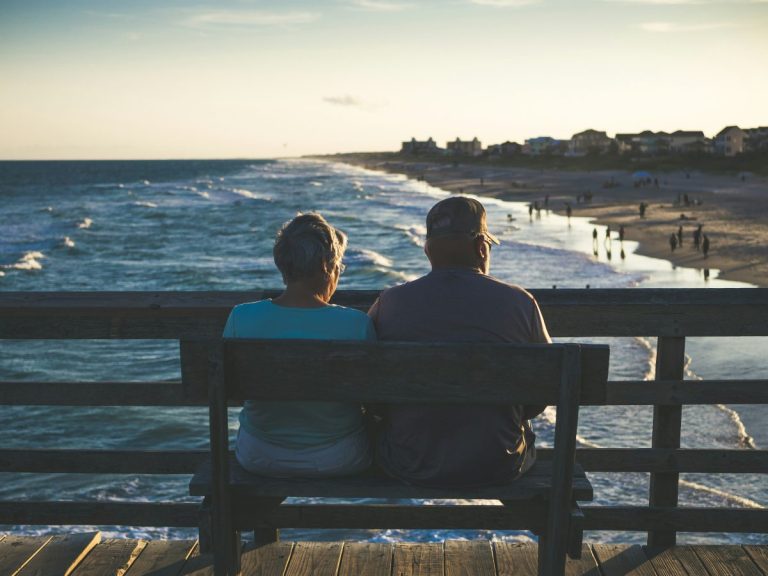 elderly couple sat alongside each other